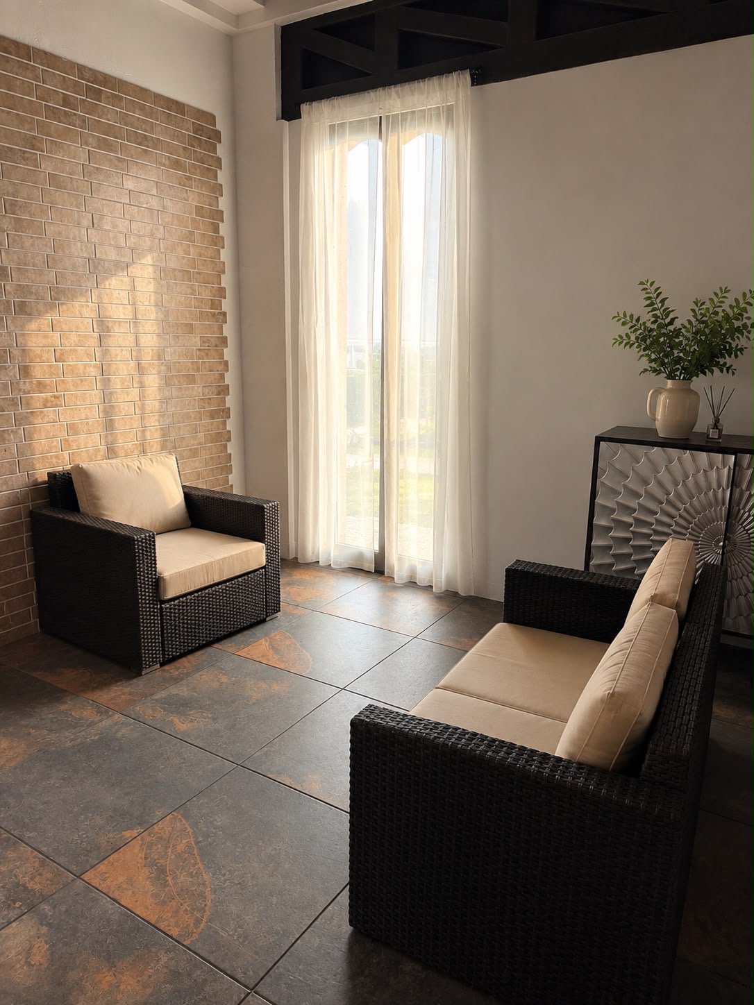 Sunlit lounge corner of the modern loft with woven armchairs and sheer curtains